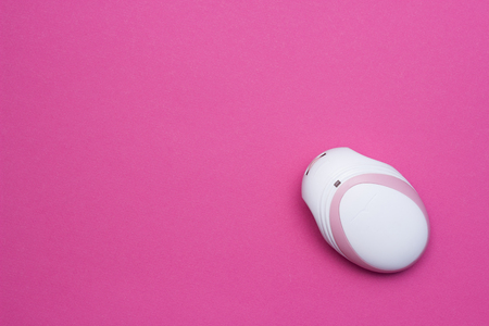 Fetal doppler for listening in a pregnant baby's heartbeat, close-up, pink background, copy spaceの写真素材