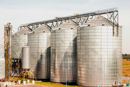 Modern farm complex for storing grain, cereals, corn and oilseed rape, agriculture, coneの写真素材