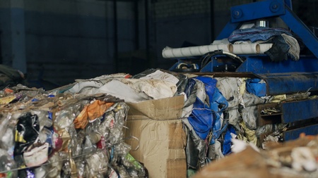 Recycling plant, pressing garbage on special equipment in bales, industryの写真素材