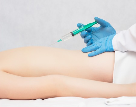 Doctor makes injection of trigger points on the girl s back, treatment of fibrosis and back pain, myofascial syndromeの写真素材