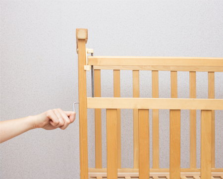 The girl collects a cot for a child, close-up, copy spaceの写真素材