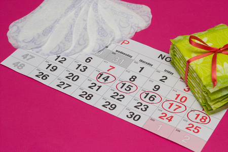 Women's calendar on which are hygienic and daily pads, pink background, copy space, gynecology, backgroundの写真素材