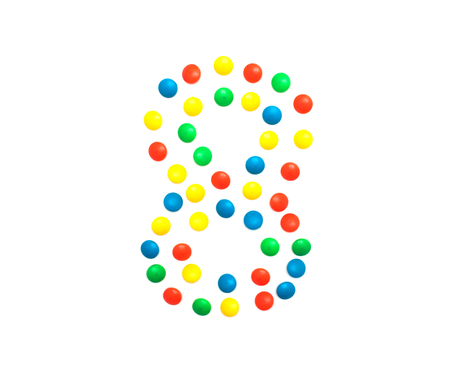 Children's numbers laid out from a multi-colored mosaic figure number 8の写真素材