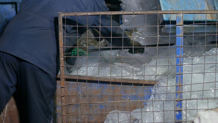 Worker sorts cellophane film at a waste recycling plant, utilization, packagingの写真素材