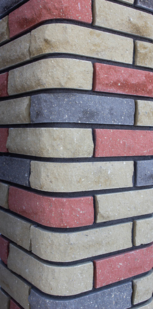 Multicolored brick column, background texture, close-upの写真素材