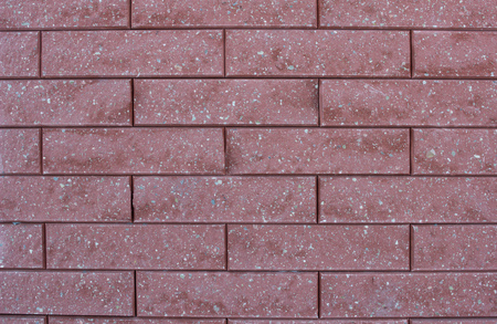 Texture of modern red brick wall with small stones, background, interiorの写真素材