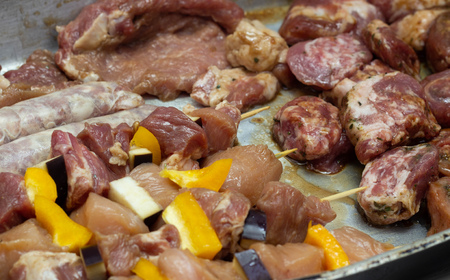 Marinated raw meat with vegetables for further frying on the barbecue, cooking meat, cooking, vegetablesの写真素材