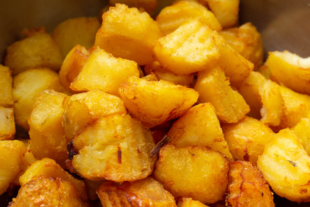 Fried potatoes with a golden crust in a deep fryer, close-up. junk food, cholesterolの写真素材