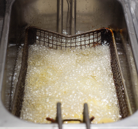 Boiling and boiling oil in which fries are fried and rustic in a fast food restaurant, background, cooked, caloriesの写真素材