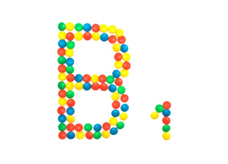 Multi-colored vitamins pills that are lined with the letter Vitamin B1, close-upの写真素材