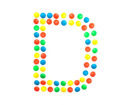 Multi-colored vitamins pills that are lined with the letter Vitamin D, close-up, medicamentの写真素材