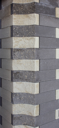 Modern brick column with brown and gray bricks, designer, texture, background, close-upの写真素材