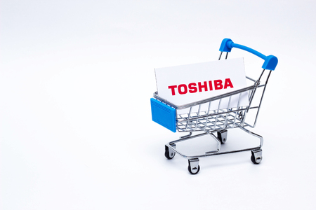 BOBRUISK, BELARUS - JANUARY 30, 2019: Shopping cart on a white background in which the business card of the corporation TOSHIBA, the brand, discountのeditorial素材