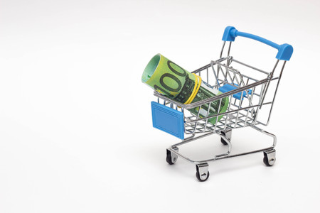 Euro money in a shopping trolley, concept of buying currency, close-up, cashの写真素材