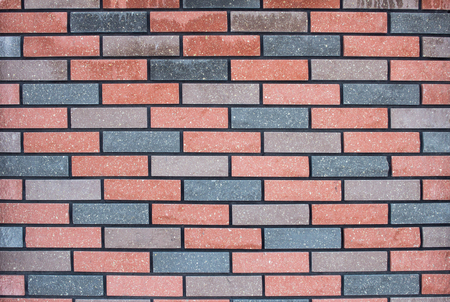 Modern designer multicolored brick wall, background, texture, architecture weatheredの写真素材