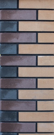 Modern brick column with brown and gray bricks, designer, texture, background, close-upの写真素材