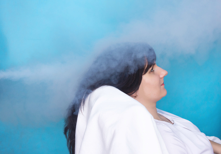 Cold treatment and cryotherapy procedure a girl sits in a chair she is treated with low temperatures in cosmetology, hair restorationの写真素材