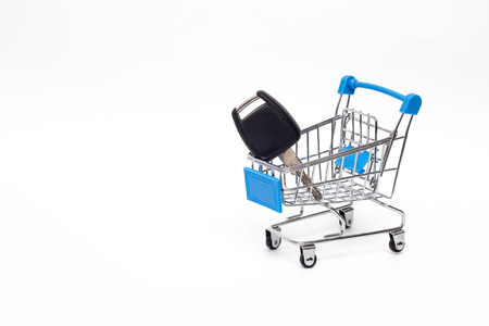Shopping cart in which the key to the car, buying a car, commercialの写真素材