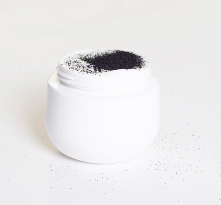 White jar with problem and dry skin care cream with activated charcoal, isolate, close-upの写真素材