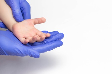 Children's hand in the hands of a pediatrician pediatric doctor concept of pediatric medicine,...