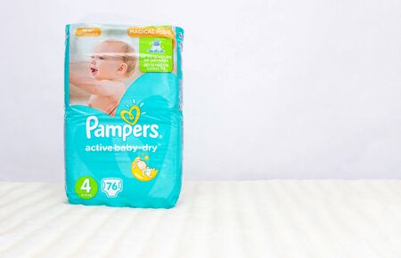 BOBRUISK, BELARUS - March 18, 2019: Baby diaper wrapping pampers on white background, copy space, protection