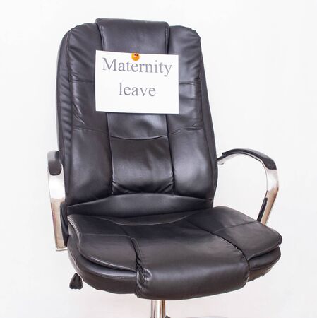 Office leather chair on which the inscription maternity leave. Childcare leave concept and maternity leave in the workplaceの写真素材