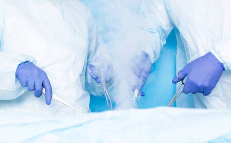 Two surgeons of Hiurge do surgery using liquid nitrogen cryotherapy to remove malignant tumors, tumors. Modern method of treatment cryosurgeryの写真素材