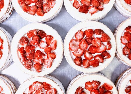 Confectionery production for the production of cakes with fresh strawberries and syrup. Red cake with fresh berry, desert, background, condensed milkの写真素材