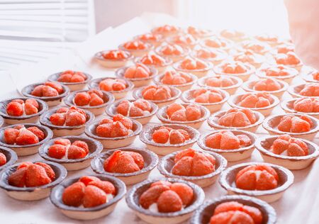 Many beautiful and tasty cakes in a tartlet with fresh strawberries, background. Summer dessertの写真素材