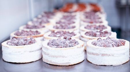Confectionery production for the manufacture of sponge cakes with fresh cherry berries and cream, dessert.の写真素材