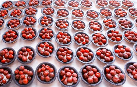 many beautiful chocolate tarts in tartlets with fresh cherry, background, traditional