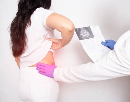 Doctor urologist holds an ultrasound examination of a patient with sick kidneys, urolithiasisの写真素材