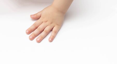 Children's little hand on a white background. The concept of children's medicine and assistance to children with disabilities, copy space, bodyの写真素材