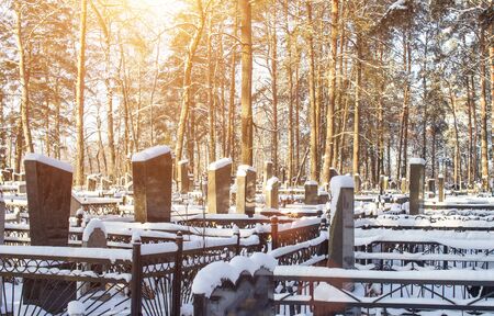 Winter time. Cemetery with monuments under the snow, background, religion