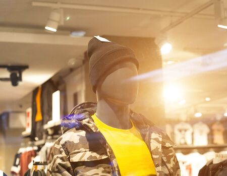 Stylish mannequin in a store in modern clothes and a hat. The concept of shopping fashion clothes in a boutique, the sun, designの写真素材