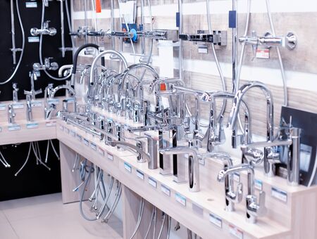 Sale of modern plumbing in the store. Water taps, kitchen and bathroom faucets, background, domesticの写真素材
