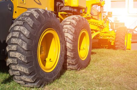 new modern grader for planning and moving soil. Road construction and leveling, industry, background