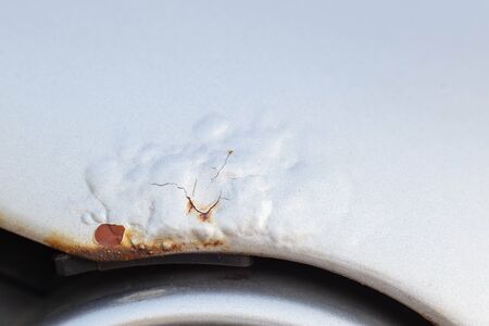 Corrosion and rust on the hood of a car. The concept of anti-corrosion treatment of the car body