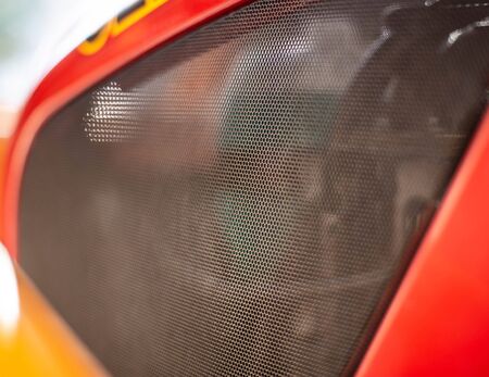 Protective net engine compartment in the car, an element of tuning. Background, copy space