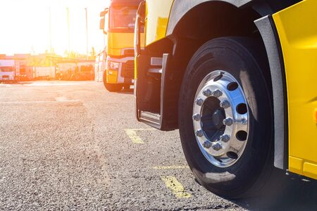 Chrome wheel of a trailer truck on asphalt, sunset. Concept of modern European tractors and cargo...