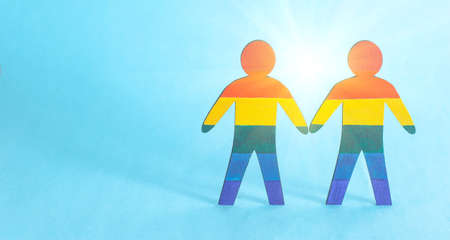 Two wooden male figures painted in multi-colored LGBT symbols. The concept of homosexuality and gay men, gay marriageの写真素材