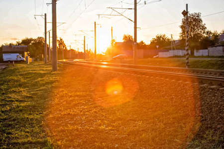 railway and railway crossing on the background of a sunny sunset, background, outdoors