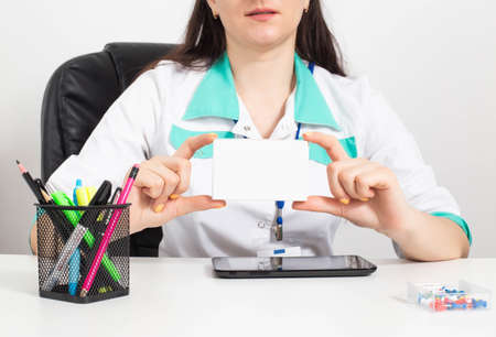 The doctor holds a pack of pills in his hands. Treating diseases of varicose veins and lowering...