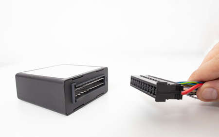 A man connects an electrical connector to an electronic climate control unit in a car. adjustment of...
