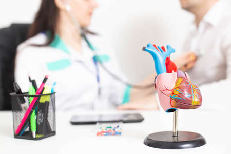 The doctor listens to the patient's heart for heart disease and congenital heart disease....