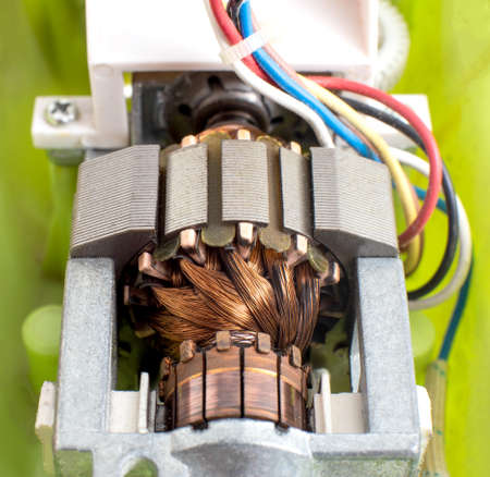 Broken electric motor in a household appliance hand mixer. Malfunction of the rotor and stator of electrical components, close-up, Engineeringの写真素材