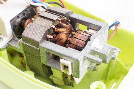 Broken electric motor in a household appliance hand mixer. Malfunction of the rotor and stator of...