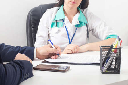 The patient signs a document for consent to anesthesia and surgery, agreement signatureの写真素材
