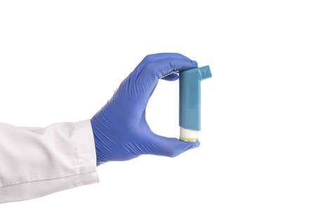 doctor's hand holds an inhaler from an attack of bronchial asthma on a white background, isolate....