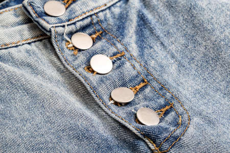 Stylish buttons on a trendy denim skirt, background, macro. Vintageの写真素材